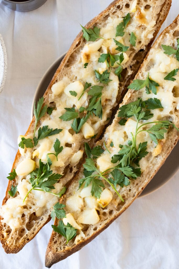 Roasted garlic bread on baguette with parsley